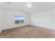 Bright bedroom with a large window offering natural light and neutral carpeting throughout at 2740 Rochelle Dr, Winter Haven, FL 33881