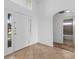 Inviting foyer showcasing tile flooring, a modern front door, and natural light streaming through the transom window at 2740 Rochelle Dr, Winter Haven, FL 33881