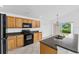 Well-equipped kitchen with wooden cabinets, modern appliances, ample counter space, and a convenient breakfast bar at 2740 Rochelle Dr, Winter Haven, FL 33881