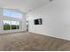 Spacious living room featuring vaulted ceilings, large windows, plush carpeting, and abundant natural light at 2740 Rochelle Dr, Winter Haven, FL 33881