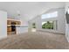 Bright and spacious living room featuring vaulted ceilings, large windows, and a seamless flow to the kitchen at 2740 Rochelle Dr, Winter Haven, FL 33881