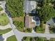 This aerial view highlights a home with a backyard pool, mature trees, and a well-kept lawn at 2800 Sunset Nw Dr, Winter Haven, FL 33881