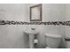 Well-maintained half-bathroom featuring stylish tiles, modern fixtures, and a pedestal sink at 2800 Sunset Nw Dr, Winter Haven, FL 33881