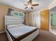 Bedroom featuring a ceiling fan, window with curtains, and an attached closet at 2800 Sunset Nw Dr, Winter Haven, FL 33881