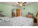 Comfortable bedroom with ceiling fan, neutral walls, and sliding closet doors at 2800 Sunset Nw Dr, Winter Haven, FL 33881