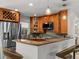 Well-lit kitchen with stainless steel appliances and bar seating at 2800 Sunset Nw Dr, Winter Haven, FL 33881