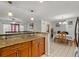 Kitchen view with granite countertops and cabinets overlooking dining and living spaces at 2800 Sunset Nw Dr, Winter Haven, FL 33881