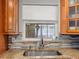 Close-up of the kitchen sink with tile backsplash and a window view at 2800 Sunset Nw Dr, Winter Haven, FL 33881