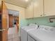 Bright laundry room features a utility sink, washer, dryer and built-in cabinets at 2800 Sunset Nw Dr, Winter Haven, FL 33881