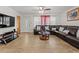 Comfortable living room with leather sectional and ample space at 2800 Sunset Nw Dr, Winter Haven, FL 33881