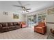Living room with tile floors, a ceiling fan, sliding glass doors, and comfortable seating at 2800 Sunset Nw Dr, Winter Haven, FL 33881