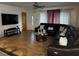 Spacious living room with tile flooring, modern ceiling fan, and a comfortable, oversized sectional sofa at 2800 Sunset Nw Dr, Winter Haven, FL 33881