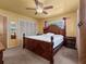 Spacious bedroom with carpet flooring, ceiling fan, and a large window with curtains at 2800 Sunset Nw Dr, Winter Haven, FL 33881