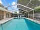 Inviting in-ground pool surrounded by a screened enclosure and ample deck space for lounging and recreation at 2800 Sunset Nw Dr, Winter Haven, FL 33881