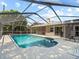 A gorgeous in-ground pool surrounded by a screened enclosure and deck space for lounging and recreation at 2800 Sunset Nw Dr, Winter Haven, FL 33881