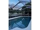 Inviting screened-in pool with sparkling, clear water, and ample privacy landscaping at 2800 Sunset Nw Dr, Winter Haven, FL 33881