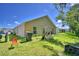 A home's backyard featuring a lawn, trash can, and recreational equipment at 286 Cove At Eagle Lake Cir, Eagle Lake, FL 33839