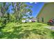 A home's backyard featuring a lawn, trees, and a fence at 286 Cove At Eagle Lake Cir, Eagle Lake, FL 33839