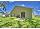 A home's backyard featuring a patio, lawn, and various recreational equipment at 286 Cove At Eagle Lake Cir, Eagle Lake, FL 33839