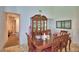 Elegant dining room featuring a wooden table, chairs, hutch, and marble tile flooring at 286 Cove At Eagle Lake Cir, Eagle Lake, FL 33839