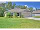 Charming single-story home featuring a well-manicured lawn and attached garage at 286 Cove At Eagle Lake Cir, Eagle Lake, FL 33839