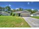 Charming single-story home featuring a well-maintained lawn, inviting entrance, and attached two-car garage at 286 Cove At Eagle Lake Cir, Eagle Lake, FL 33839