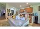 Open kitchen featuring laminate counters, wooden cabinetry, and stainless-steel appliances at 286 Cove At Eagle Lake Cir, Eagle Lake, FL 33839
