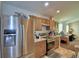 Kitchen with stainless steel appliances, wooden cabinets, and laminate countertops at 286 Cove At Eagle Lake Cir, Eagle Lake, FL 33839