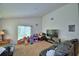 Cozy living room with plush carpet, a large window, and comfortable leather sofas at 286 Cove At Eagle Lake Cir, Eagle Lake, FL 33839