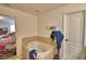 Bright bathroom features a tile-surround bathtub and a doorway leading to the main bedroom at 286 Cove At Eagle Lake Cir, Eagle Lake, FL 33839