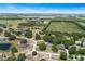 Aerial view showcases a residential area amid lush greenery, with neatly planned agricultural fields and a clear, blue sky at 2861 Pond View Dr, Haines City, FL 33844