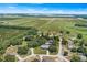 Stunning aerial view of homes near beautiful farmland on a sunny day with a blue sky and scattered clouds at 2861 Pond View Dr, Haines City, FL 33844