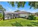 Green backyard with the pool and screened enclosure in the background at 2861 Pond View Dr, Haines City, FL 33844