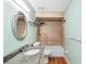 Bathroom with granite countertop, decorative mirror, and tile and wood flooring at 2861 Pond View Dr, Haines City, FL 33844