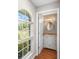 Powder room showcasing white cabinets, granite countertop, and wood flooring at 2861 Pond View Dr, Haines City, FL 33844
