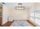 Dining room with light wood floors and an elegant chandelier with shuttered window at 2861 Pond View Dr, Haines City, FL 33844