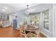 The dining room showcases large windows, modern lighting, and hardwood floors, leading into the living room at 2861 Pond View Dr, Haines City, FL 33844