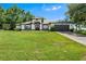 Beautiful single-story home with a manicured lawn and a dark garage door at 2861 Pond View Dr, Haines City, FL 33844