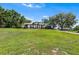 View of the house with a well-kept lawn and a long driveway leading to an attached garage at 2861 Pond View Dr, Haines City, FL 33844