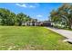 Home with manicured lawn and a driveway that leads to an attached garage, all beneath a clear sky at 2861 Pond View Dr, Haines City, FL 33844