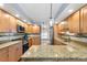 Spacious kitchen featuring granite countertops, stainless steel appliances, and ample cabinet space at 2861 Pond View Dr, Haines City, FL 33844