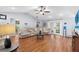 Comfortable living room with laminate flooring, a ceiling fan and french doors to the pool at 2861 Pond View Dr, Haines City, FL 33844
