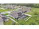 Expansive aerial view of a home with solar panels and a screened pool enclosure in a residential neighborhood at 308 Kissengen Park Dr, Bartow, FL 33830