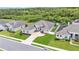 Aerial view of gray home featuring solar panels, manicured lawn, fenced yard, and mature landscaping at 308 Kissengen Park Dr, Bartow, FL 33830