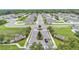 Aerial view of a neighborhood entrance showcasing landscaping and orderly streets lined with well-maintained homes at 308 Kissengen Park Dr, Bartow, FL 33830