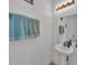 This bathroom features a pedestal sink with a mirror and lighting and decorative hand towels at 308 Kissengen Park Dr, Bartow, FL 33830