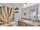 Colorful bathroom offering vanity with sink and decorative shower curtain at 308 Kissengen Park Dr, Bartow, FL 33830