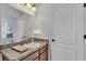Bright bathroom features a countertop sink with vanity, large mirror and lighting at 308 Kissengen Park Dr, Bartow, FL 33830