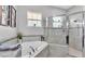 Bathtub with a gray tile surround next to a glass shower at 308 Kissengen Park Dr, Bartow, FL 33830