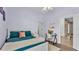 Bedroom with hardwood floors, ceiling fan and closet is staged with workspace adjacent to the bed at 308 Kissengen Park Dr, Bartow, FL 33830